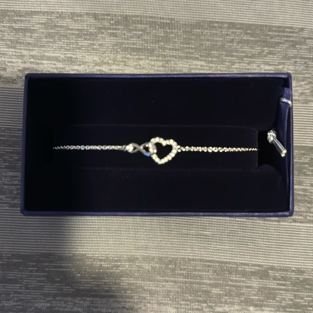 Brand new Swarovski heart with infinity bracelet.